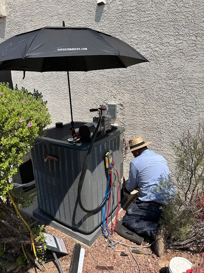 HVAC technician performing outdoor AC maintenance in Port St. John